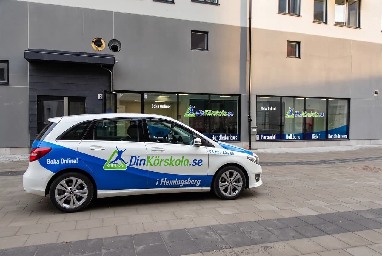 Din Körskolas bil utanför skolan i Flemingsberg